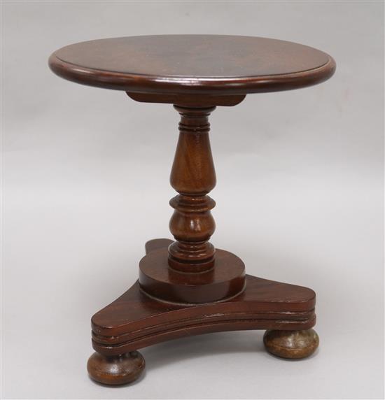 A Victorian miniature mahogany circular topped dining table